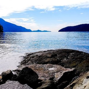 Rocky shoreline at Kelvin Grove Beach Park in Lions Bay, looking out over Howe Sound to forested islands