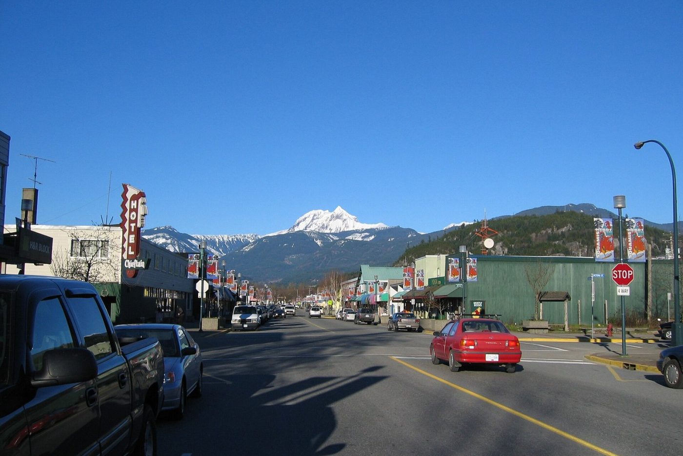 Cleveland Avenue, downtown Squamish's main street, with shops on both sides and a snow-capped peak beyond