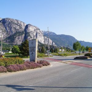 The Squamish Town Centre sign on Cleveland Avenue, with the granite face of the Stawamus Chief behind it