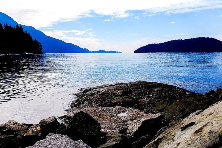 Rocky shoreline at Kelvin Grove in Lions Bay, looking across Howe Sound to forested islands