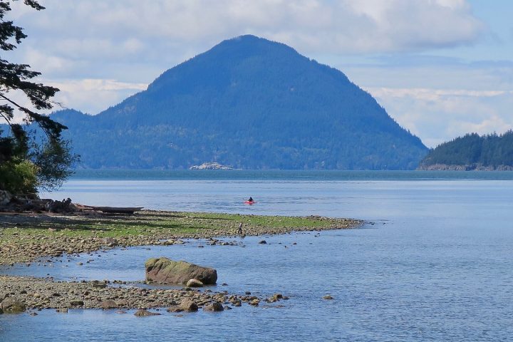 Pebble beach at Porteau Cove at low tide, with a forested mountain rising across Howe Sound