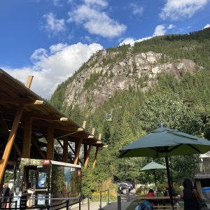 Sea to Sky Gondola base area with a cabin climbing toward the granite face of the Stawamus Chief