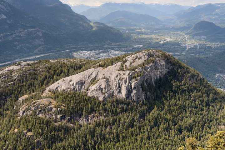 The granite dome of the Stawamus Chief rising out of the forest above Squamish, seen from the Sea to Sky Gondola's Chief Overlook
